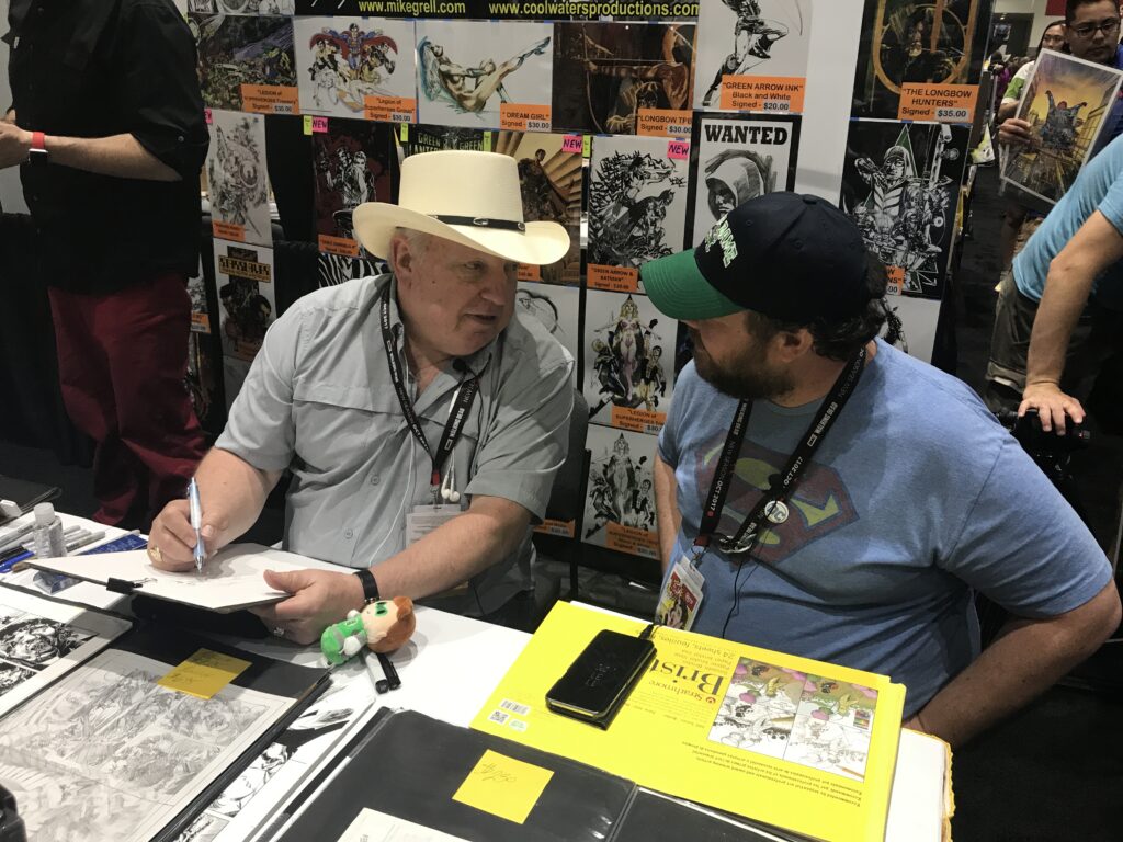 Kenric talking to Mike Grell while he draws at SDCC 2017.
