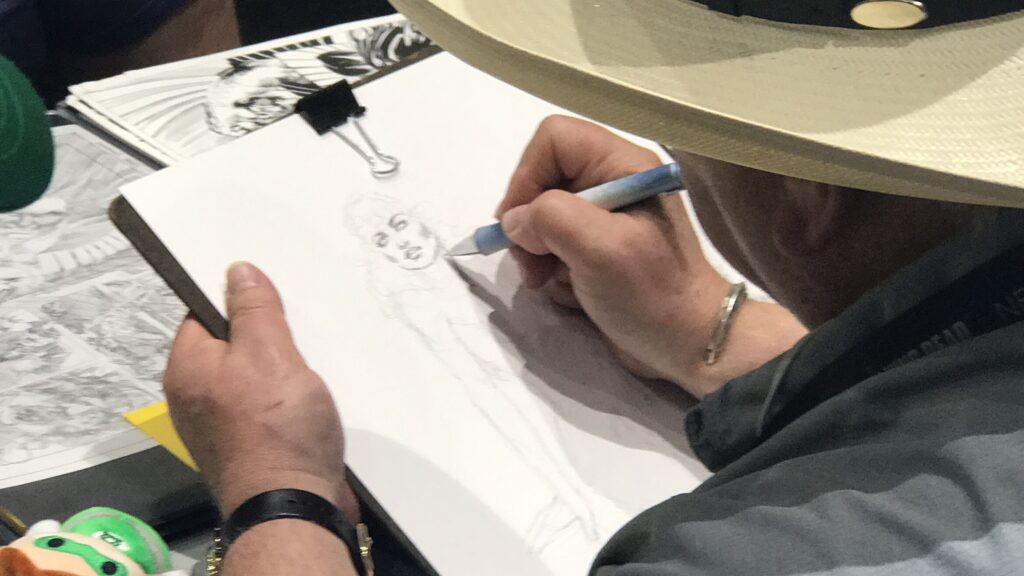 Mike Grell working on his drawing at SDCC 2017.